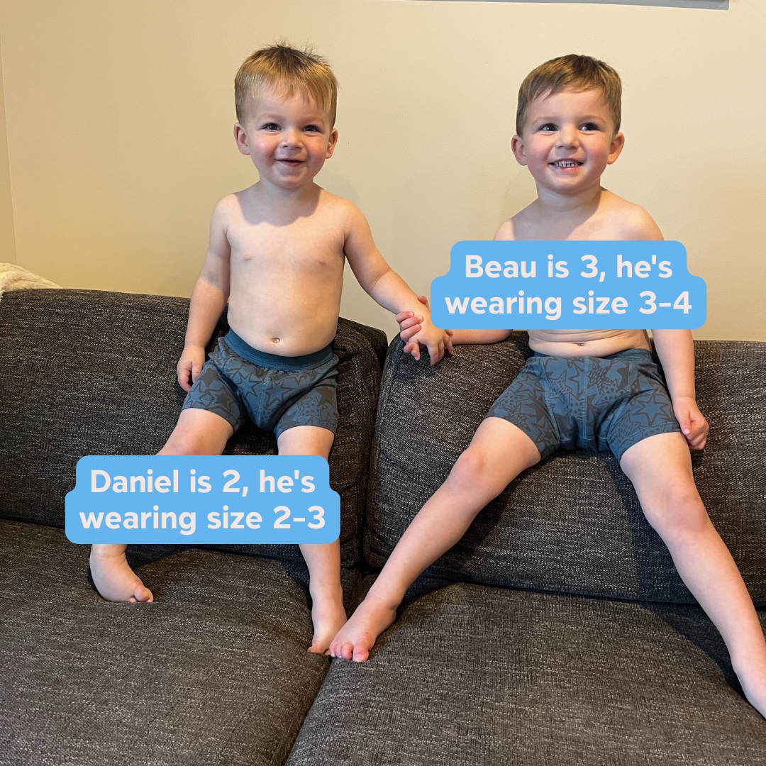 Two young boys sitting on a couch wearing matching Snazzi Pants Night Trainers - Rock Star