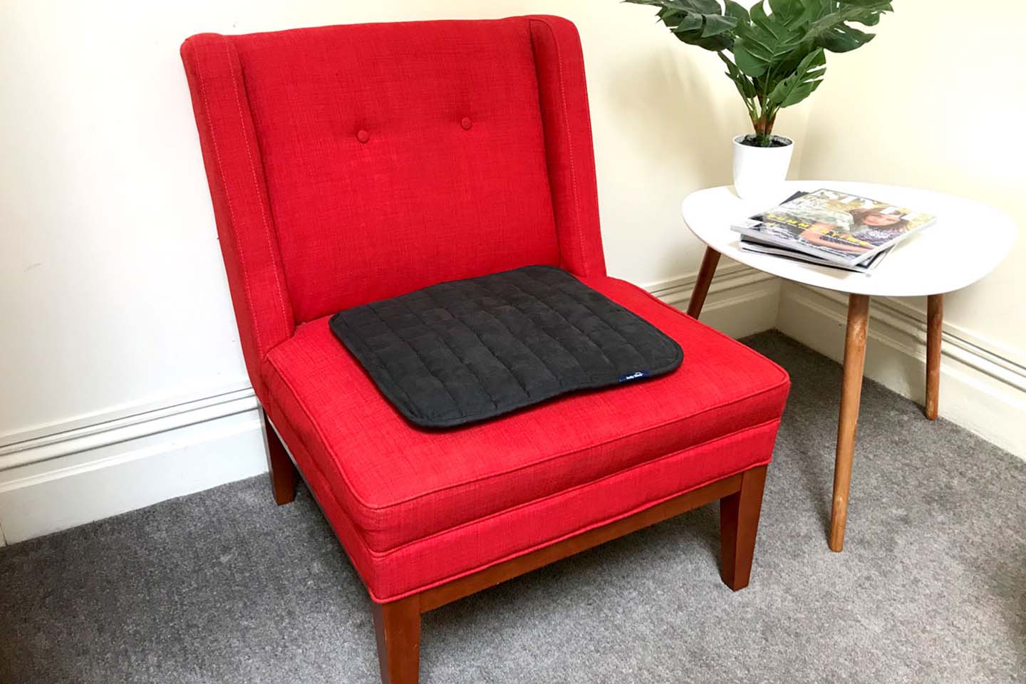 Red chair with black chair pad