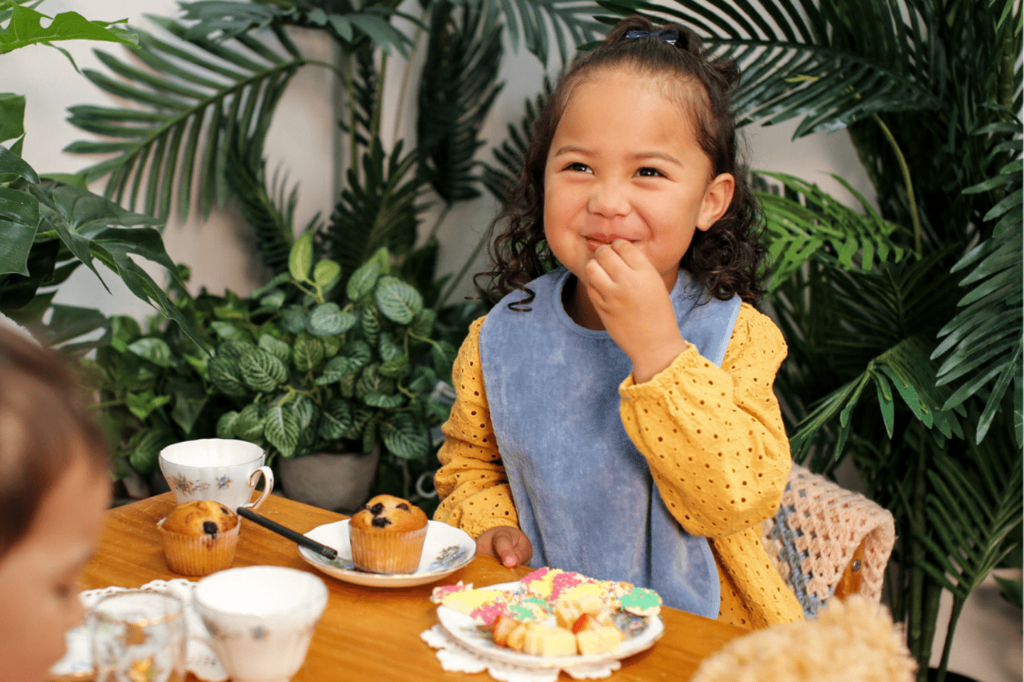 Toddler and Baby having a tea party in our Smokey Blue Extra Absorbent Bib and our Pink Extra Absorbent Bib