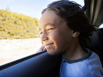 Boy in car on a road trip 