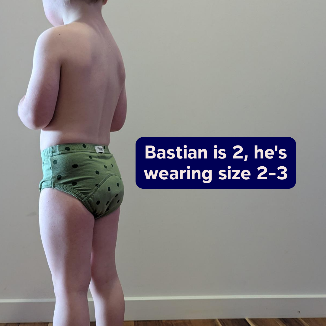 Child wearing a size 2-3 Snazzi Pants Day Trainer, standing against a plain wall - Sprouty Spots