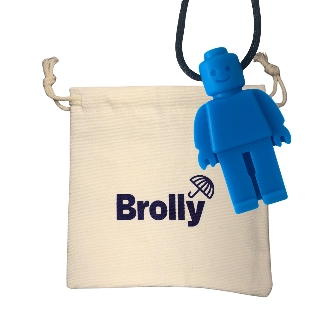 Beige drawstring pouch and robot-shaped Brolly Sheet Chew Necklace on a black cord against a white background - Blue