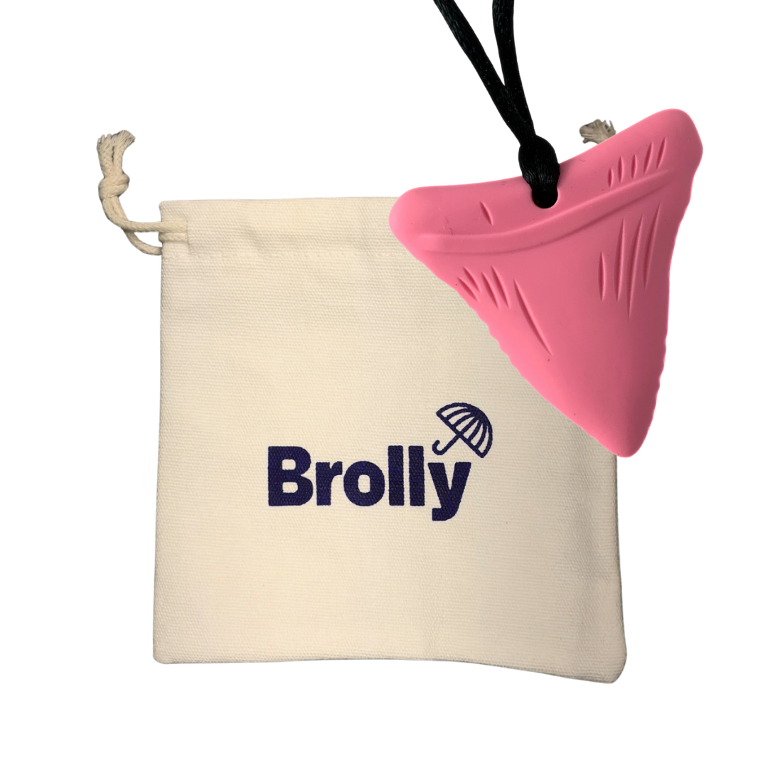 Beige drawstring pouch and Shark Tooth-shaped Brolly Sheet Chew Necklace on a black cord against a white background - Pink