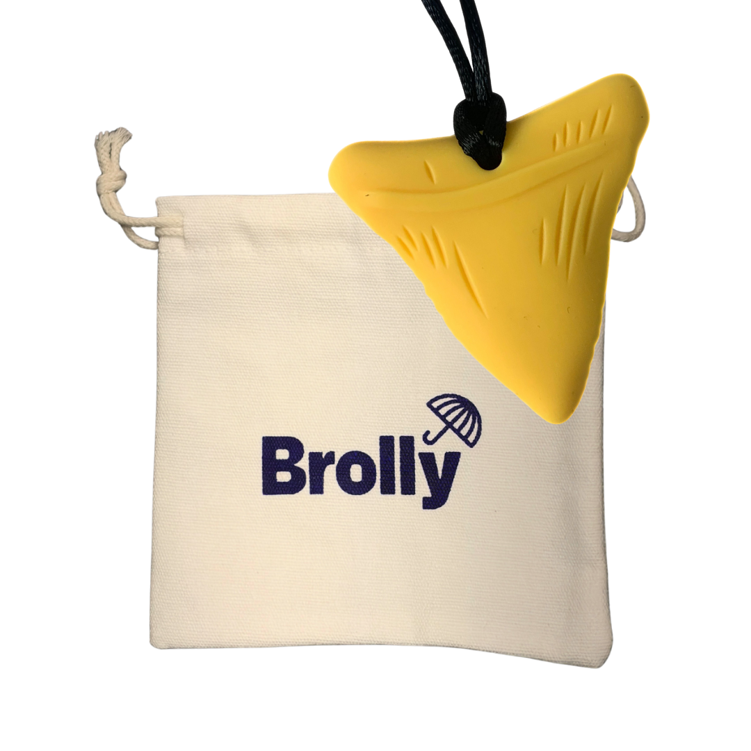 Beige drawstring pouch and Shark Tooth-shaped Brolly Sheet Chew Necklace on a black cord against a white background - Yellow