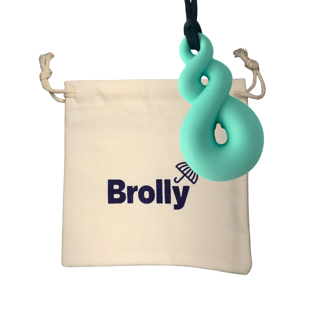 Beige drawstring pouch and Triple Loop-shaped Brolly Sheet Chew Necklace on a black cord against a white background - Mint