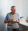 Adult Tray Bib with man having cup of tea
