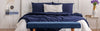 QUeen bed dressed with Navy Blue sheets and pillow cases