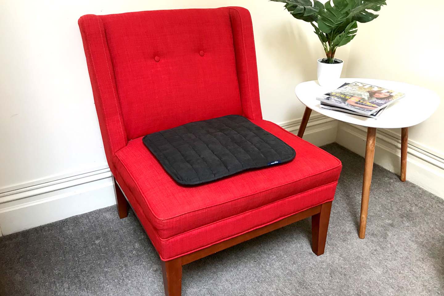 Red chair with black chair pad 